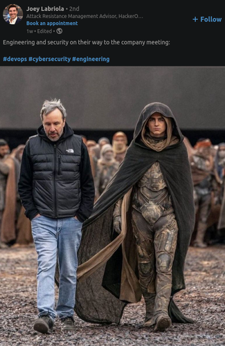 Screenshot from Linkedin captioning a picture "Engineering and security on their way to the company meeting." The picture looks like a behind-the-scenes shot from the Dune movie with a grey-haired bearded guy in a north face jacket and jeans walking next to a guy in a draping black cloak and camouflage. 