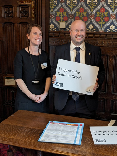 Marie from Back Market with Patrick Grady MP, who is holding a sign that says 'I support the Right to Repair'.
