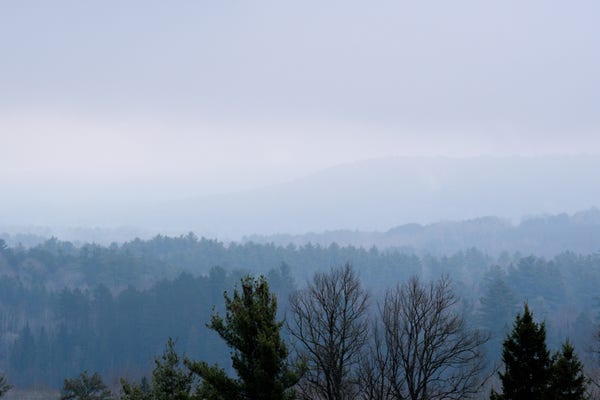 The view to the east. The hills are wrapped in layers of mist.