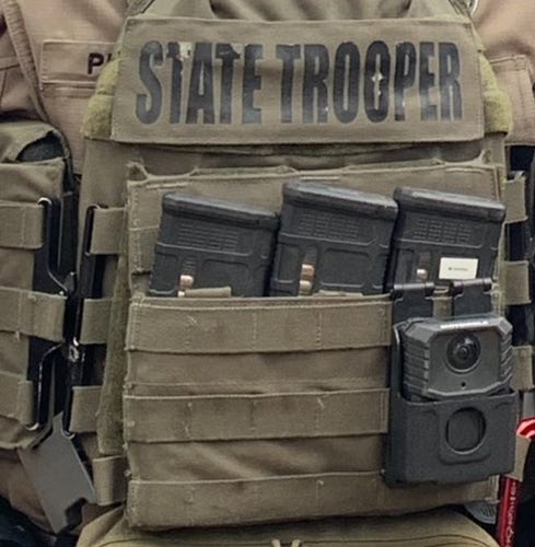 Close up shot of a State Trooper flak jacket crammed with bullet clips for an AR-15
