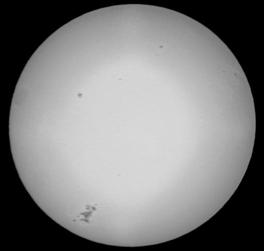 Photo of sun with various smaller spots and the big spot (splotch?) causing flares. 