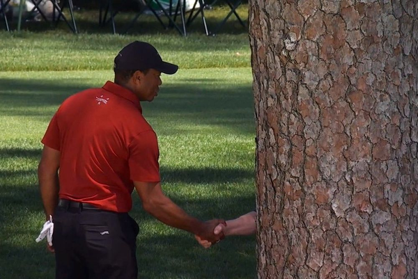 Tiger Woods shares a handshake with longtime broadcaster Verne Lundquist, whose body was blocked by a tree, at the Masters tournament in Augusta, Ga. on April 14th, 2024.
