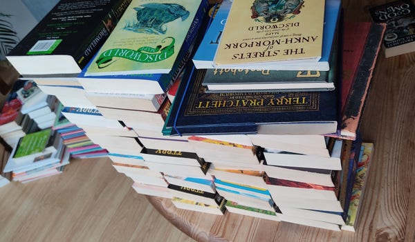 A big pile of books on a table 
