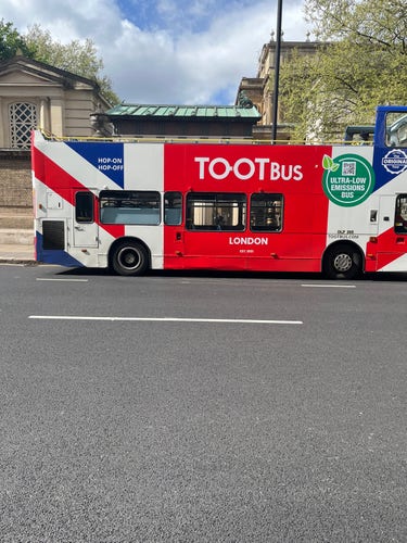 A double-decker bus in London bearing the legend TOOTbus