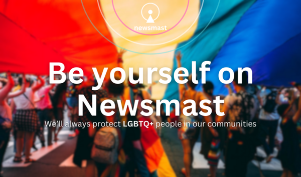 Text: Be yourself on Newsmast. We'll always protect LGBTQ+ people in our communities.

Image: A group of people marching under a large pride flag.