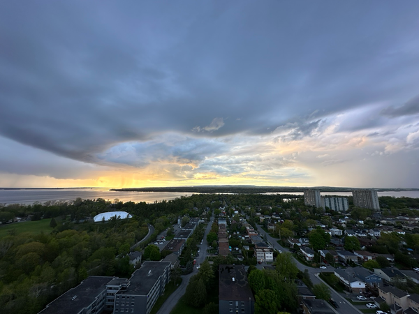 Storm clouds move past a sunset along the Ottawa River as the storm passes over the Britannia area of Ottawa 