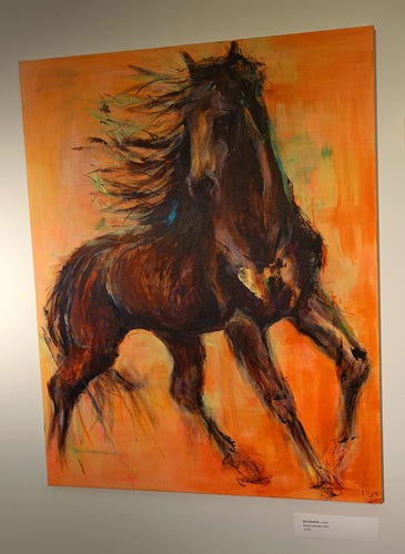 A black horse and an orange background 