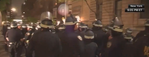 A huge crowd of riot police on the streets of New York - timestamped 9.05pm local time.