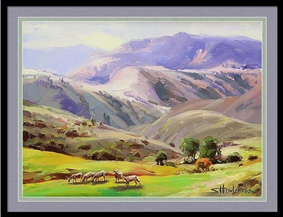 Framed print of an original oil painting depicting a herd of deer grazing in a green meadow at the foothills of the mountains.