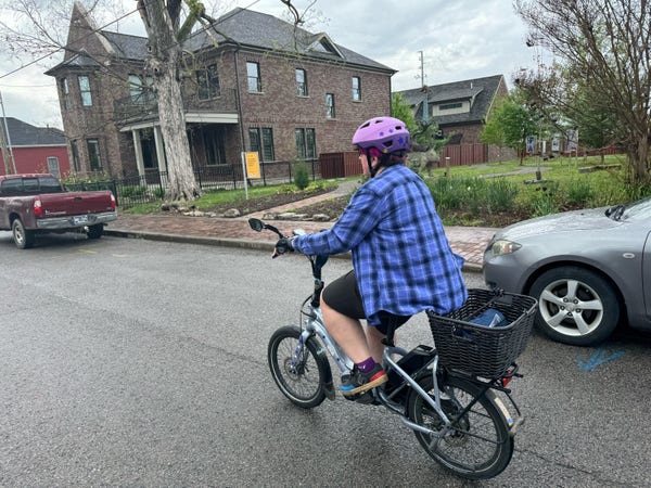 Person on a bike, on a neighborhood street