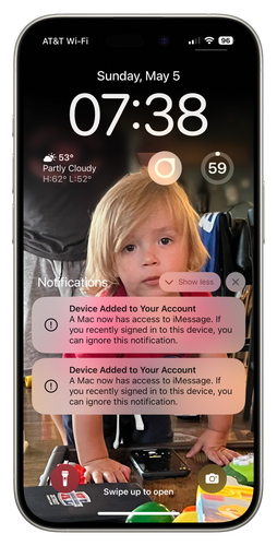 iPhone home screen showing notifications of devices being added to iCloud with a young child as the cover art.