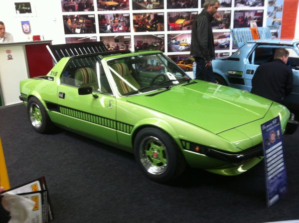 Green metallic Fiat X1/9, front quarter view