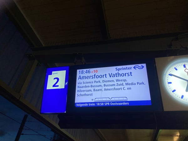 A platform information display showing the 18:46 Sprinter to Amersfoort Vathorst as ten minutes late.