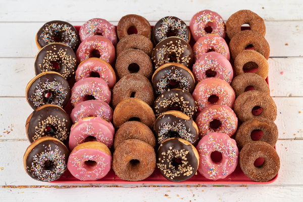 25 colourful doughnuts on a tray