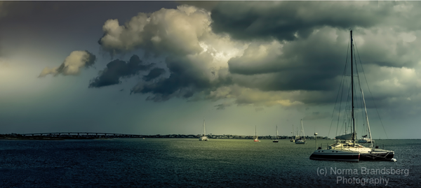 St Augustine Florida harbor with a moored peaceful catamaran sailboat, storm clouds overhead panorama, buy here:

https://www.pictorem.com/977289/Storm%20Clouds%20Overhead.html