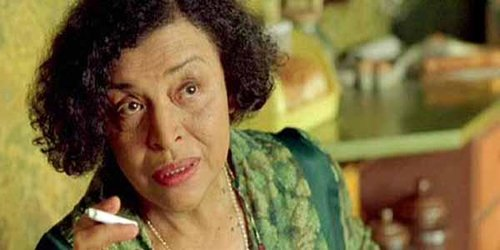 the Oracle from The Matrix (Gloria Foster), holding a cigarette
