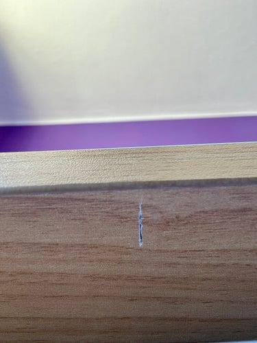 View of desk underside showing a cut groove running front to back