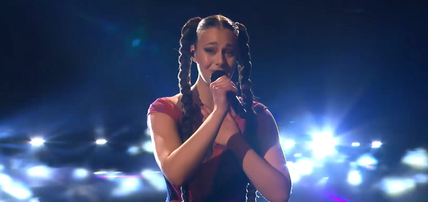 Luxembourg female singer on Eurovision 2024 stage.