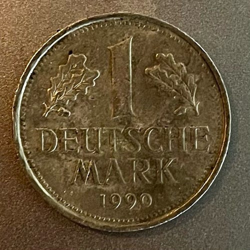 The front of a German 1 mark coin from 1990, so after reunification. 