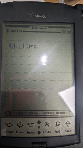 An old PDA with a new note and current date and time