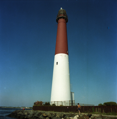 A lighthouse with an intense blue sky behind it. 