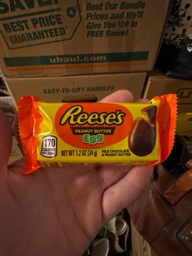 Wrapped Reese’s peanut butter egg in front of boxes