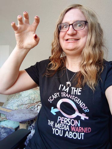 Me in a t-shirt saying "I'm the scary transgender person the media warned you about". I'm staring wildly, showing my teeth, and making a claw at the camera, showing off my red-painted fingernails.
Actually the scariest thing about this photo is the state of my hair, damn.
