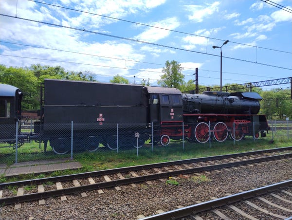 Photo of a large steam locomotive painted black and red
