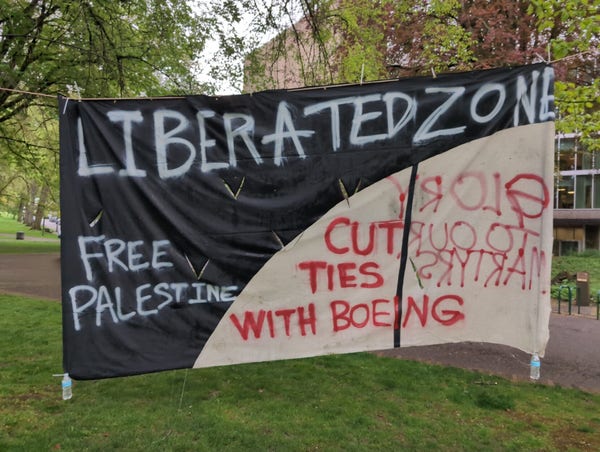 a very big banner hangs between, i reads: "liberated zone! free palestine! cut ties with boeing!"