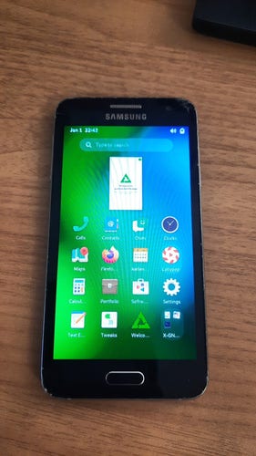 A Samsung Galaxy A3 running postmarketOS with GNOME Shell mobile.