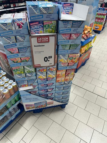 Display of Durstlöscher beverage multi-packs in a grocery store with a price sign for 0.89 euros.