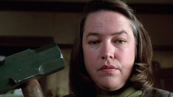 Kathy Bates character in Stephen King's MISERY... holding a sledgehammer in front of the end of the bed of the James Caan character