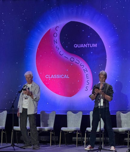 I'm on the right, father on the left. In the middle, the The Science of Consciousness ident logo this year. It kinda looks like a Pepsi-flavoured yin and yang symbol with consciousness written down the middle and 'classical' and 'quantum' on each side.