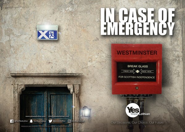 A fire exit sign with a Saltire over a door in a wall. To the right the message "IN CASE OF EMERGENCY" over a large red case containing a button marked "Break Glass Scottish Independence." (YES West Lothian)