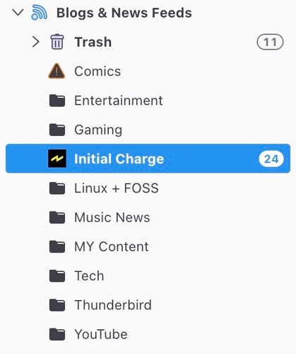 Screenshot of a menu from a blog and news feed application showing various categories such as Trash, Comics, Entertainment, and others, with the 'Initial Charge' category highlighted and indicating 24 new items.