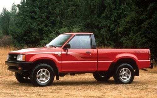 A photograph of a red 1990 Mazda B2200 pickup truck with a standard cab and 6 foot bed.